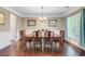 Formal dining room featuring dark wood floors, wainscoting, and a chandelier at 173 Silver Cypress Cir, Summerville, SC 29485