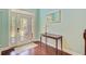 Inviting foyer with decorative glass front door, wooden floors, and soft blue walls at 173 Silver Cypress Cir, Summerville, SC 29485