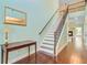 This foyer features wood flooring, a staircase with iron spindles, and a traditional wood side table at 173 Silver Cypress Cir, Summerville, SC 29485