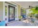 Cozy front porch featuring comfortable seating, decorative plants, and a ceiling fan at 173 Silver Cypress Cir, Summerville, SC 29485
