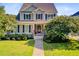 Charming two-story home with a well-manicured lawn, flowering trees, and welcoming front porch at 173 Silver Cypress Cir, Summerville, SC 29485