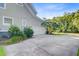 Attached two-car garage with a paved driveway and manicured landscaping at 173 Silver Cypress Cir, Summerville, SC 29485