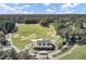 Aerial view of the golf course and clubhouse featuring lush green fairways, mature trees, and manicured landscaping at 173 Silver Cypress Cir, Summerville, SC 29485