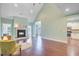 Spacious living room with a fireplace, wood floors, and a view into the kitchen at 173 Silver Cypress Cir, Summerville, SC 29485