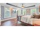 Serene main bedroom features tray ceilings, hardwood floors, and a large window at 173 Silver Cypress Cir, Summerville, SC 29485