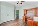 Well lit room featuring hardwood flooring, desk with cabinets, and a door leading to the staircase at 173 Silver Cypress Cir, Summerville, SC 29485