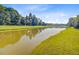 Picturesque view of a serene pond with manicured grassy shoreline at 173 Silver Cypress Cir, Summerville, SC 29485