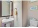 Cozy powder room offering pedestal sink, framed mirror, and neutral wall paint at 173 Silver Cypress Cir, Summerville, SC 29485