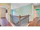 A well-lit staircase with dark wood railings and iron spindles leads to the upper level at 173 Silver Cypress Cir, Summerville, SC 29485