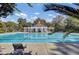 Community swimming pool showcasing a covered area with lounge chairs and clean blue water, framed by lush greenery at 173 Silver Cypress Cir, Summerville, SC 29485
