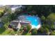 Aerial view of a community pool with lounge chairs, umbrellas, and a clubhouse, perfect for relaxation and recreation at 190 Darcy Ave, Goose Creek, SC 29445