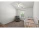 Neutral Bedroom with a ceiling fan, window, and a chair next to a crib at 190 Darcy Ave, Goose Creek, SC 29445