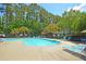 Community pool featuring clear blue water, lounge chairs, and surrounding greenery at 190 Darcy Ave, Goose Creek, SC 29445