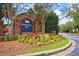 Community entrance sign surrounded by vibrant flower beds, shrubbery, and tall trees at 190 Darcy Ave, Goose Creek, SC 29445