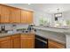 Spacious kitchen featuring wood cabinets, stainless steel sink, and modern appliances at 190 Darcy Ave, Goose Creek, SC 29445