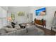 Open living room featuring hardwood floors, a comfortable gray sofa, and a mounted TV at 190 Darcy Ave, Goose Creek, SC 29445
