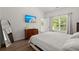 Bedroom featuring hardwood floors, a comfortable bed, and a mounted TV at 190 Darcy Ave, Goose Creek, SC 29445