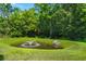 Scenic pond featuring a fountain surrounded by a well-maintained green lawn and lush greenery at 190 Darcy Ave, Goose Creek, SC 29445
