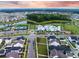 Aerial view of homes in a community with a pool, clubhouse, tennis courts, and pond at 203 Symphony Ave, Summerville, SC 29486