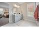 Bathroom with a double sink vanity, tiled floors, and doorway to bedroom at 203 Symphony Ave, Summerville, SC 29486