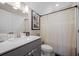 Bright bathroom featuring a modern vanity, decorative accents, and a neutral-toned shower curtain at 203 Symphony Ave, Summerville, SC 29486