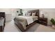 Warm bedroom featuring a wooden bed frame, neutral decor, and matching nightstands with lamps at 203 Symphony Ave, Summerville, SC 29486