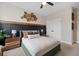 Bedroom features a striking headboard, decorative wall art, contemporary nightstands, and neutral carpet at 203 Symphony Ave, Summerville, SC 29486
