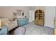 Bedroom with soft rocking chair, patterned rug, and pastel-colored furniture at 203 Symphony Ave, Summerville, SC 29486