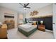 Stylish bedroom showcases a comfortable bed, designer headboard, decorative wall art, and modern ceiling fan at 203 Symphony Ave, Summerville, SC 29486