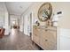 Stylish entryway with decorative cabinet, round mirror, and hardwood floors at 203 Symphony Ave, Summerville, SC 29486