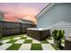 Outdoor hot tub on a patio with checkerboard grass and stone tiles at 203 Symphony Ave, Summerville, SC 29486