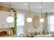 Kitchen decor featuring globe pendant lights, trailing plants, and woven wall art at 203 Symphony Ave, Summerville, SC 29486