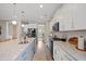 A kitchen island with a sink, granite countertops, stainless steel appliances and white cabinets at 203 Symphony Ave, Summerville, SC 29486