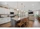 A kitchen with white cabinets, stainless steel appliances, granite countertops, an island, and pendant lighting at 203 Symphony Ave, Summerville, SC 29486
