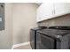 Laundry room is equipped with modern, front-loading washer and dryer units and ample cabinet space at 203 Symphony Ave, Summerville, SC 29486