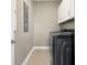 Practical laundry room is equipped with modern, front-loading washer and dryer units and ample cabinet space at 203 Symphony Ave, Summerville, SC 29486