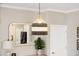 Close up of the stylish dining room pendant light fixture with neutral colors and woven materials at 203 Symphony Ave, Summerville, SC 29486