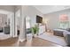 Open living room features hardwood floors, a decorative mirror, mounted TV, and a cozy seating area at 203 Symphony Ave, Summerville, SC 29486