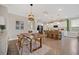 Open concept dining and kitchen area with a modern table set and kitchen island at 203 Symphony Ave, Summerville, SC 29486