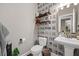 Modern powder room showcases patterned wallpaper, floating shelves, and a pedestal sink at 203 Symphony Ave, Summerville, SC 29486