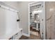 View of modern powder room showcases patterned wallpaper and floating shelves, seen from hallway at 203 Symphony Ave, Summerville, SC 29486