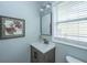 Bathroom vanity featuring a framed mirror, neutral paint, and a window letting in natural light at 204 Foxborough Rd, Goose Creek, SC 29445