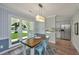 Charming dining area featuring natural light, modern lighting fixture, and an open layout to adjacent kitchen space at 204 Foxborough Rd, Goose Creek, SC 29445
