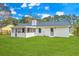Rear exterior view of a white brick single Gathering home featuring a well-manicured lawn at 204 Foxborough Rd, Goose Creek, SC 29445