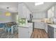 Bright kitchen featuring white cabinetry, stainless steel appliances, and a cozy dining area at 204 Foxborough Rd, Goose Creek, SC 29445