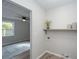 Laundry room features a built in shelf, neutral paint, wood-look floors and an opening into another room at 204 Foxborough Rd, Goose Creek, SC 29445