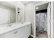 Bathroom featuring a double vanity with white cabinets and a shower with a marble curtain at 217 Black Tupelo Ct, Moncks Corner, SC 29461