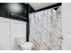 Bathroom features a toilet with a white marble shower curtain and black accent wall at 217 Black Tupelo Ct, Moncks Corner, SC 29461