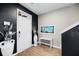 Inviting entryway with striking black accent wall, light wood floors, and stylish decor at 217 Black Tupelo Ct, Moncks Corner, SC 29461