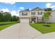 Charming two-story home with a well-manicured lawn and a long driveway leading to the garage at 217 Black Tupelo Ct, Moncks Corner, SC 29461